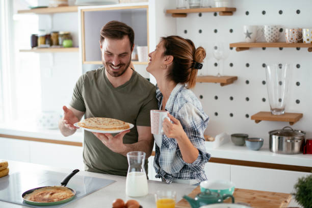 istock Husband and wife making pancakes at home 1284191743