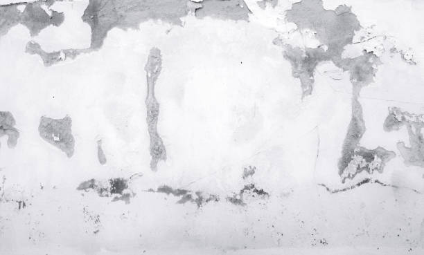 istock Old white concrete wall are peeling. Painted concrete wall abstract texture background. Deteriorated over time. Cracked cement wall. Empty white wall texture background for minimal life. 1284192298