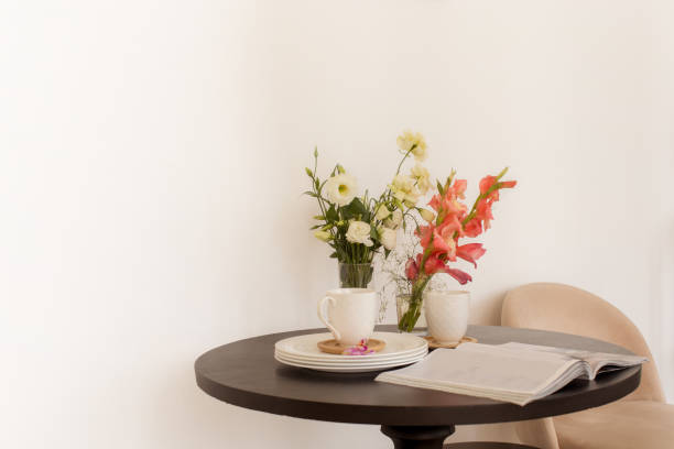 istock Flowers and magazine near dishware on table 1284192394