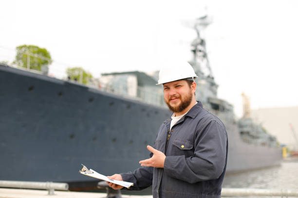 istock DDE, designated duty engineer, reading documents and standing near vessel 1284193460