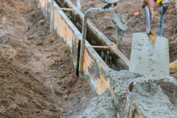 istock Concrete construction contractor installing a sidewalk, curb on a new urban road 1284193484