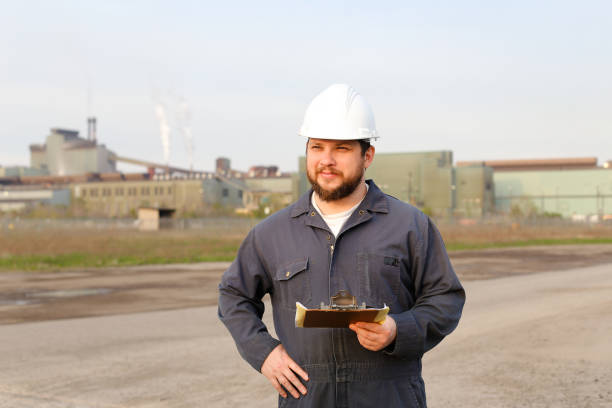 istock Portrait of engineer standing on construction site and holding papers 1284193980