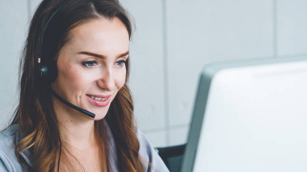 istock Business people wearing headset working in office 1284194737