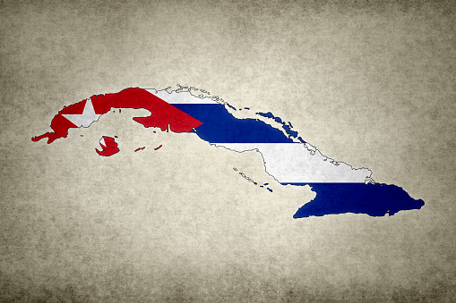 Grunge map of Cuba with its flag printed within its border on an old paper.