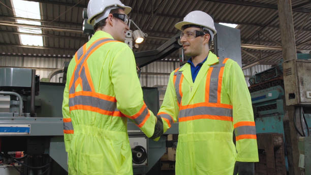 istock Factory workers handshake with team member in the factory 1284194792
