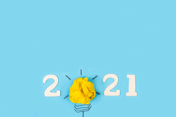 istock 2021 year greeting with a bulb made with paper 1284195077