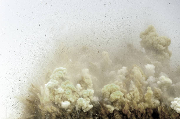 Splash of rock after blast Dust clouds and rock particles after dynamite blast on the construction site in the middle east land mine stock pictures, royalty-free photos & images