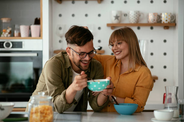 istock Young couple eating breakfast at home. 1284195982