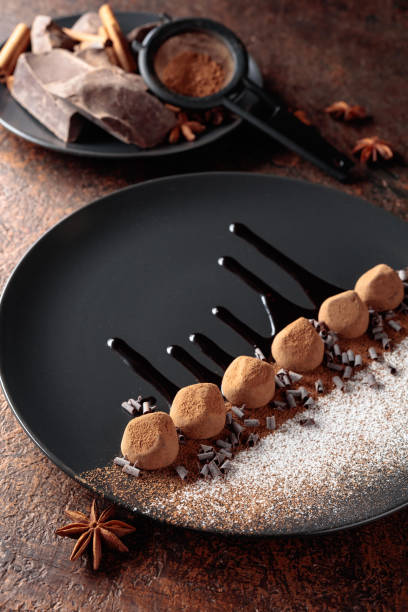 istock Chocolate truffles on a black plate with chocolate sauce. 1284196198