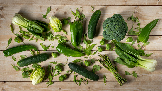 Green vegetables on wooden table for background