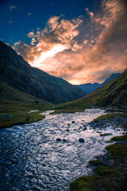 Mountain landscape in the alps. The beautiful river flowing between alpine meadows in the lap of Himalaya, Parvati valley on a trek to Hamta Pass, 4270 m on the Pir Panjal range in Himalaya, India. View during trek to Hamta Pass.Mountain landscape in the alps. The Sun has set, beautiful river flowing between alpine meadows in the lap of Himalaya, Parvati valley on a trek to Hamta Pass, 4270 m on the Pir Panjal range in Himalaya, India. himachal pradesh photos stock pictures, royalty-free photos & images