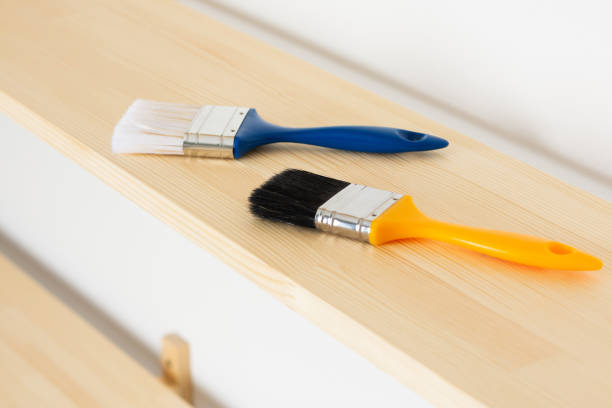 istock Paint brushes are on a wooden shelf 1284198601