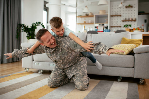istock Soldier having fun with his son at home. 1284199864