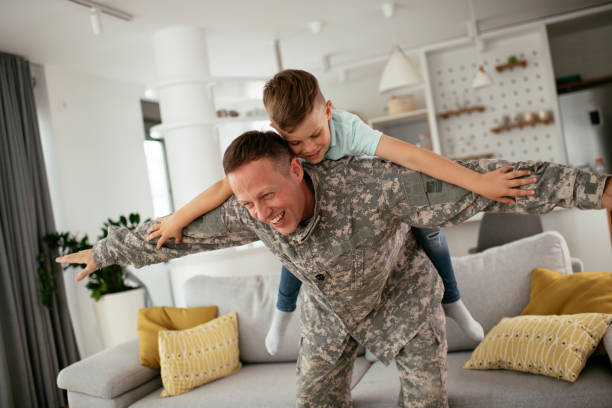 istock Soldier having fun with his son at home. 1284199866