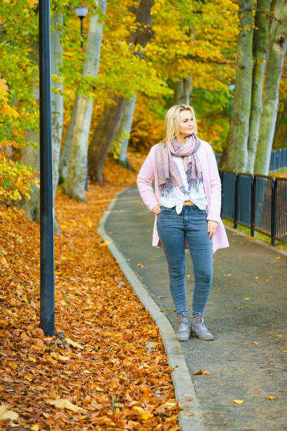 istock Woman walking in autumn park 1284199984