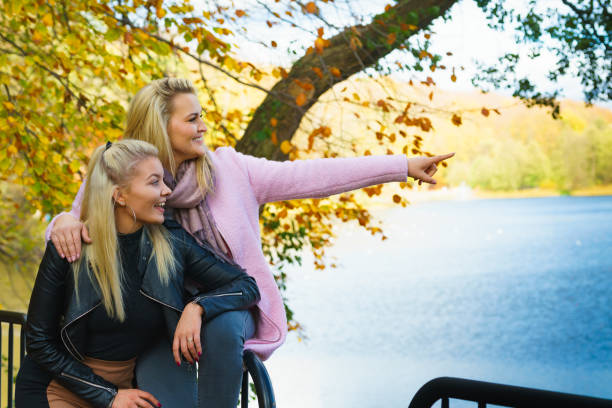istock Two women walking in autumn park 1284200280