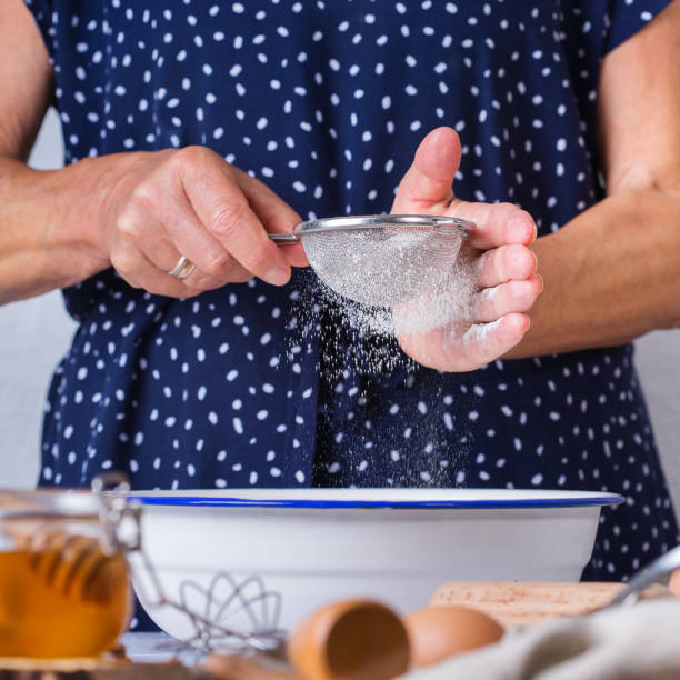 istock Senior woman cooking, kneading dough, baking in the kitchen 1284200557