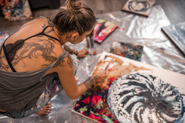istock Female Artist working in her studio 1284201381