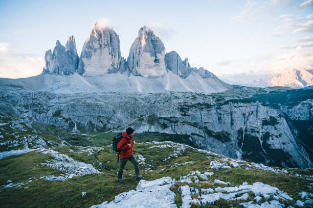 istock Man hikes along a mountain ridge at sunrise 1284202414