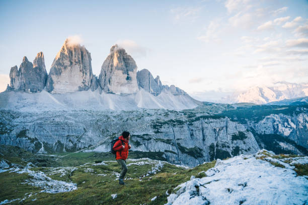 istock Man hikes along a mountain ridge at sunrise 1284202421