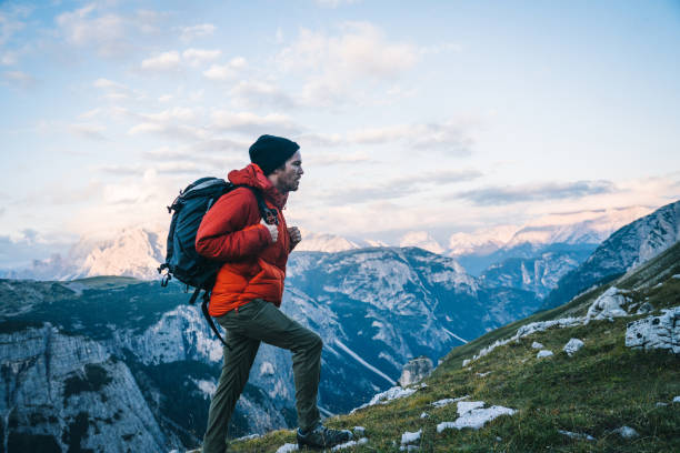 istock Man hikes along a mountain ridge at sunrise 1284202456