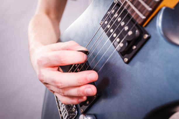 istock Close up of man playing on electric guitar 1284202486