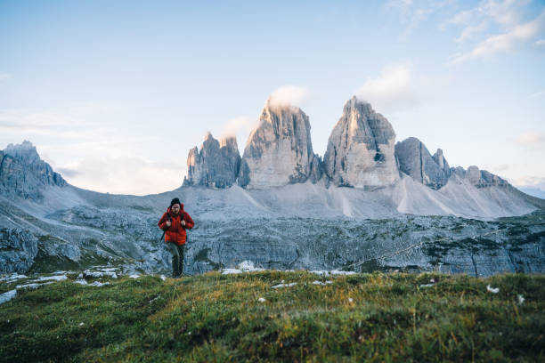 istock Man hikes along a mountain ridge at sunrise 1284202768