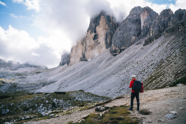 istock Male hiker traverses path on mountain ridge crest 1284203069