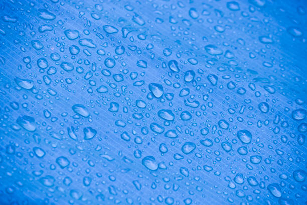 istock Water-repellent fabric in large raindrops. Blue rip-stop fabric. Tent textiles. Waterproof material. 1284204514