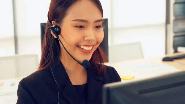 istock Business people wearing headset working in office 1284204637