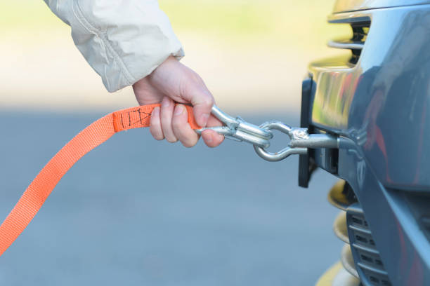 Yellow tow rope attached to a car on the road