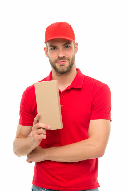 istock For delivery. Package boy in uniform isolated on white. Delivery man hold box. Parcel delivery. Express delivery courier service. Parcel post package, copy space 1284205744