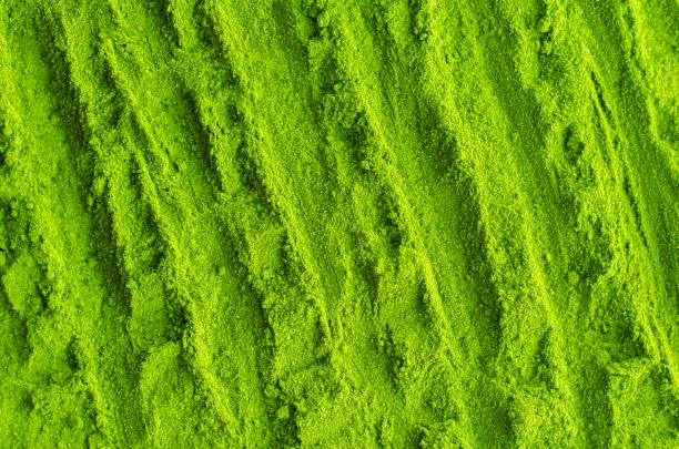 Matcha powder background. Green tea texture close-up, selective focus