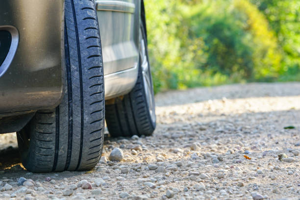 istock Selective focus of typical summer tire on gravel road with copy space 1284208400