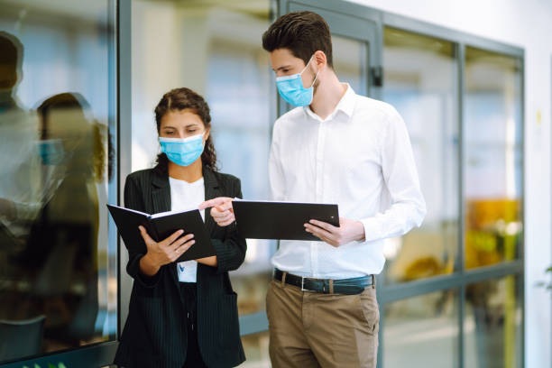 istock Two manager in protective face masks having an argument discussing business Issue. 1284209211