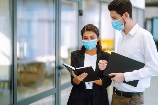 istock Two manager in protective face masks having an argument discussing business Issue. 1284209212