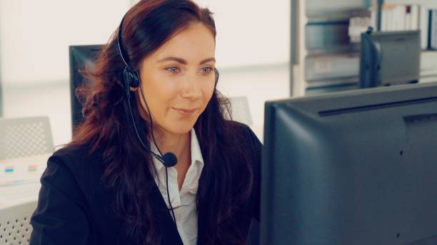 istock Business people wearing headset working in office 1284209868