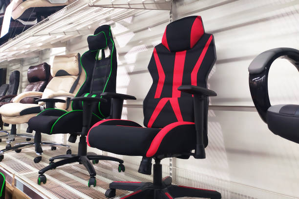 Different computer gamer soft ergonomic chairs in the furniture store Different computer gamer soft ergonomic chairs in the furniture store. gaming chair photos stock pictures, royalty-free photos & images