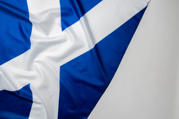 istock Rippled flag of Scotland lying on white surface 1284211823