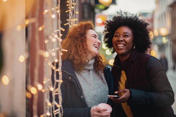 istock Two female friends outdoors during winter using smart phone 1284214146