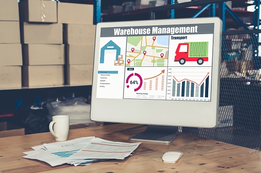 Warehouse management software application in computer for real time monitoring of goods package delivery . PC screen showing smart inventory dashboard for storage and supply chain distribution .