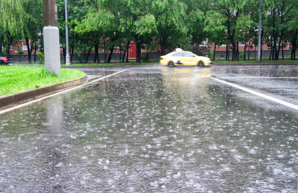 istock Heavy rain on the road. Puddles on the asphalt. 1284216779