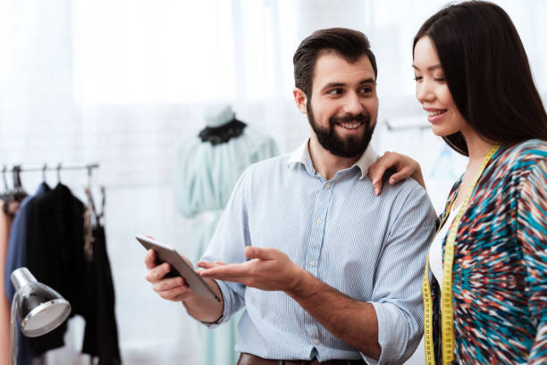 istock Two fashion designers looking at tablet. 1284216823