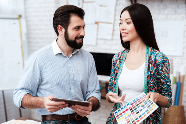 istock Two fashion designers looking at tablet. 1284216930