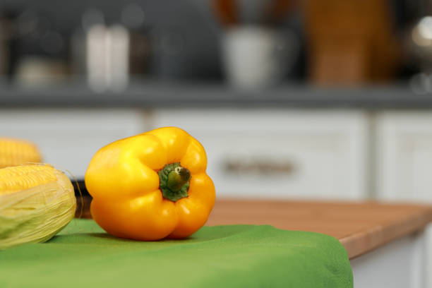 Fresh ripe bell pepper on wooden kitchen table
