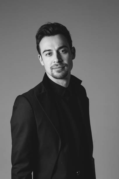 istock Studio portrait of a young man in a black blazer against plain studio background 1284218187