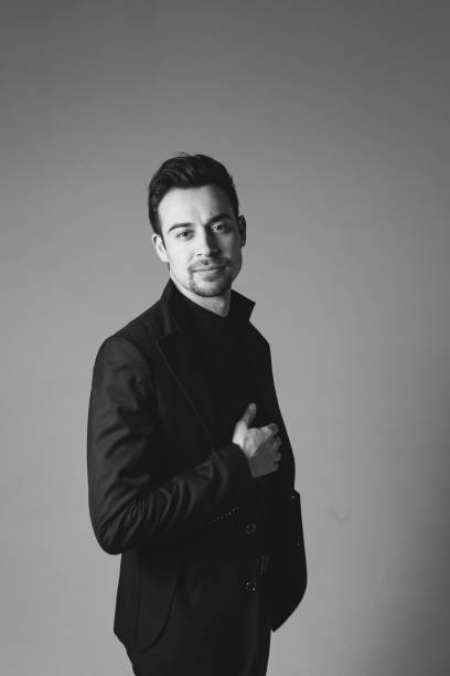 istock Studio portrait of a young man in a black blazer against plain studio background 1284218190