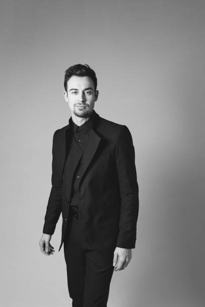 istock Studio portrait of a young man in a black blazer against plain studio background 1284218196
