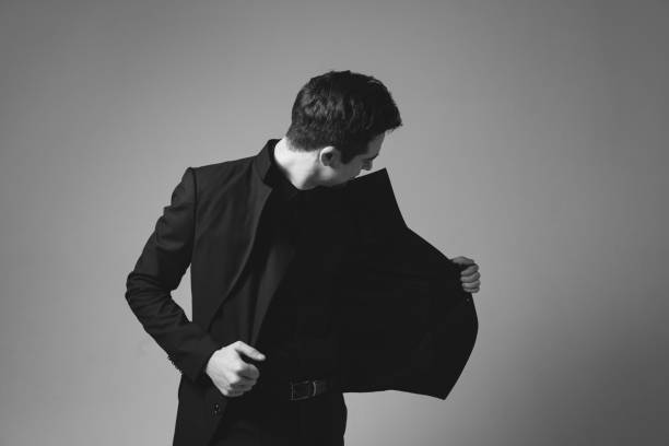 istock Studio portrait of a young man in a black blazer against plain studio background 1284218202