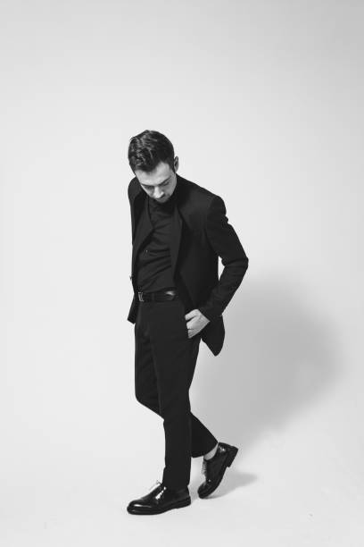 istock Studio portrait of a young man in a black blazer against plain studio background 1284218204